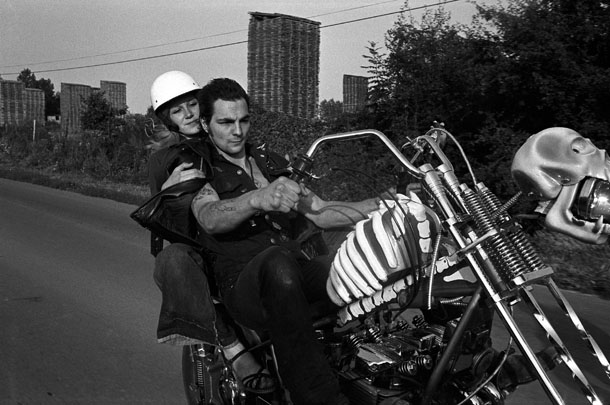 Yan Morvan. Suburbs of Paris, 1977. From Bikers. A gang leader Tesos is driving his motorbike.