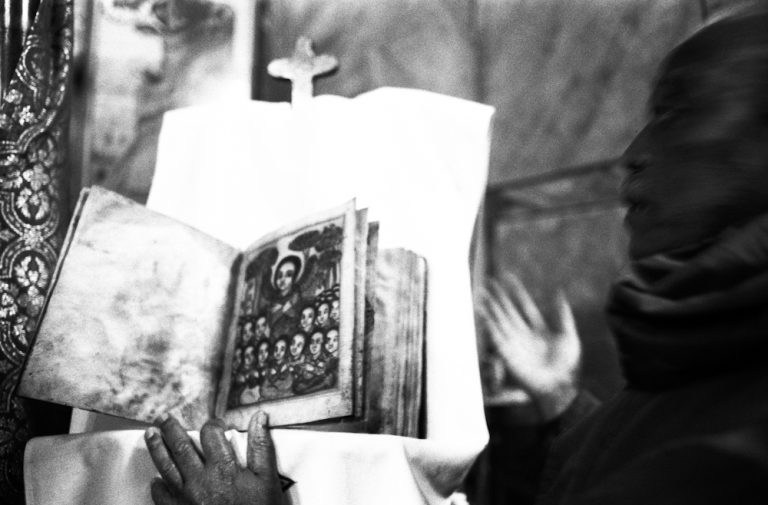 Linda Dorigo. Jerusalem, December 2012. In the Ethiopian church near Damascus Gate, the guardian shows an ancient version of the Bible. In the Christian community of Jerusalem between Damascus Gate and Jaffa Gate, the Catholic, Orthodox, Egyptians and Ethiopians are divided between small spaces and winding paths.